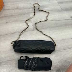 Black quilted umbrella case with small black umbrella inside no name case